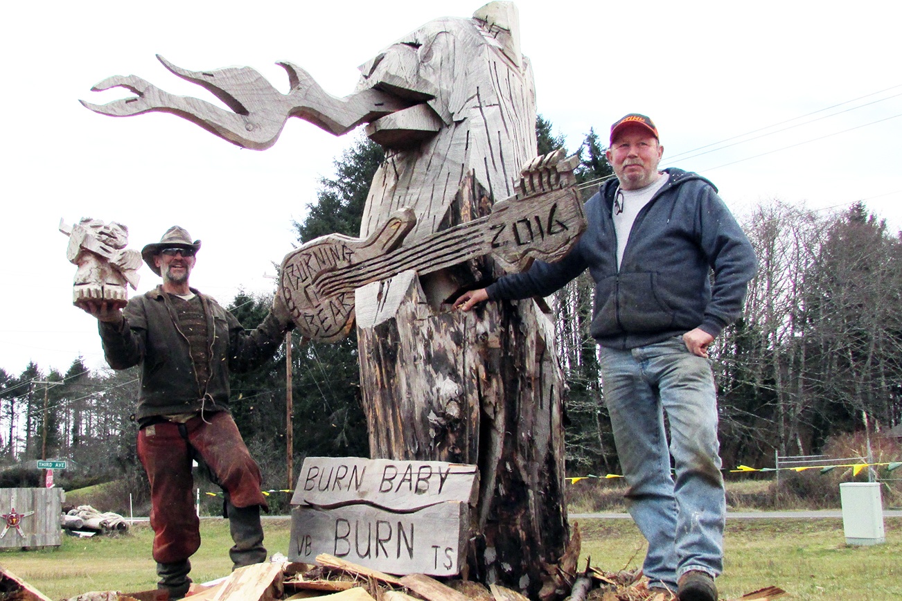 Scott D. Johnston photo: Burning Bear co-founder Ivan Hass, right, and carver James Haskett, of Butte, MT, look forward to lighting up the massive wooden sculpture Saturday around dusk at the event held at Ocean City Marketplace on SR 109. Photo by Scott D. Johnston