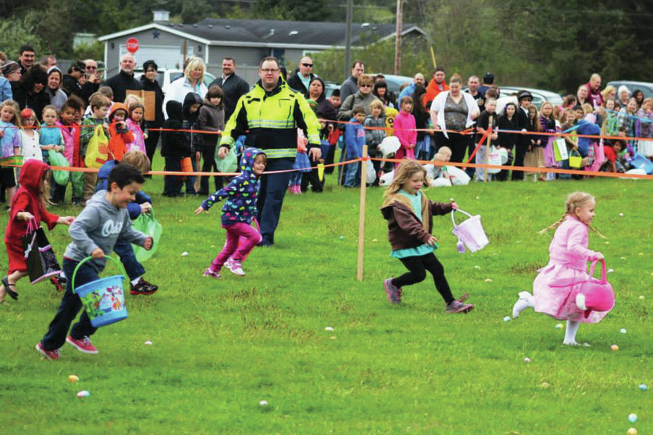 Angelo Bruscas/North Coast News: Ocean Shores Fire Capt. Brian Ritter, now the interim Fire Chief, supervises as the wave of younger kids head out through the field laden with Easter Eggs at the Ocean Shores Elementary School.