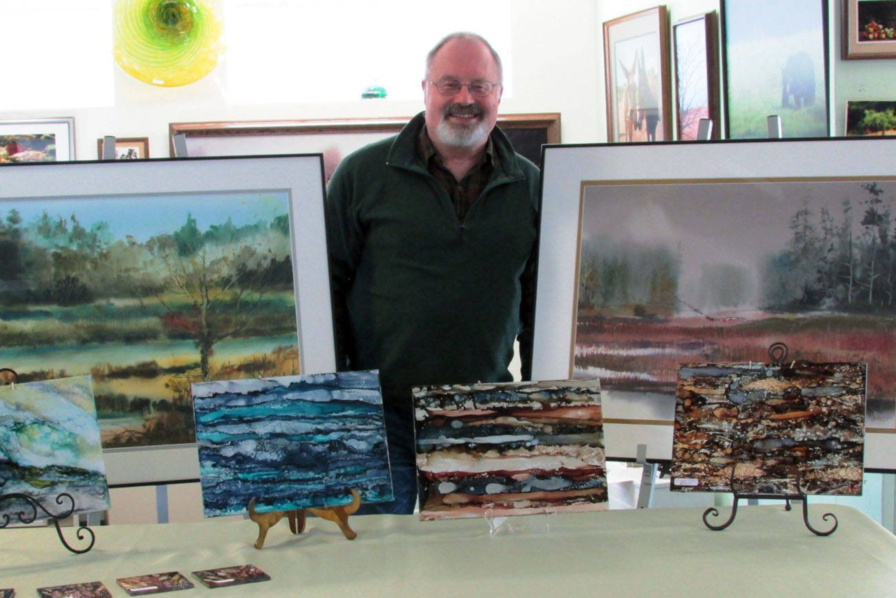 Scott D. Johnston photo: Ocean Shores artist Roy Lowry stands in front of some of his paintings. The local artist enjoys teaching others of all skill levels and has several classes available starting in April.