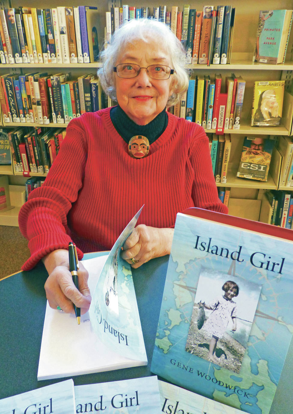 North Coast News: Gene Woodwick signing her book, “Island Girl.”
