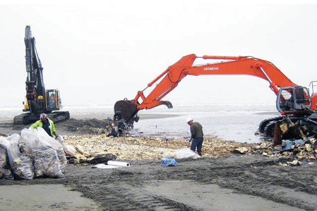 North Coast News photo of salvage work to clear the last remnants of the Privateer from the beach near the North Jetty.