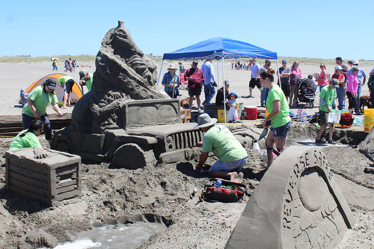 Angelo Bruscas/North Coast News photo: The Form Finders team prepares the final touches to its entry in the Ocean Shores Sand & Sawdust competition June 24 on the beach in Ocean Shores.
