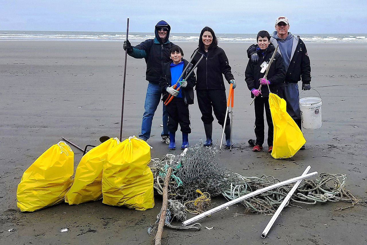 Lourdes Collins photo The Collins and Sterling families from Olympia help to clean the beach south of Point Grenville last April for the Washington Coast Cleanup. Pictured are Steve Collins, Rob and Christy Sterling, Tristan Sterling (12) and Tyson Sterling (9).
