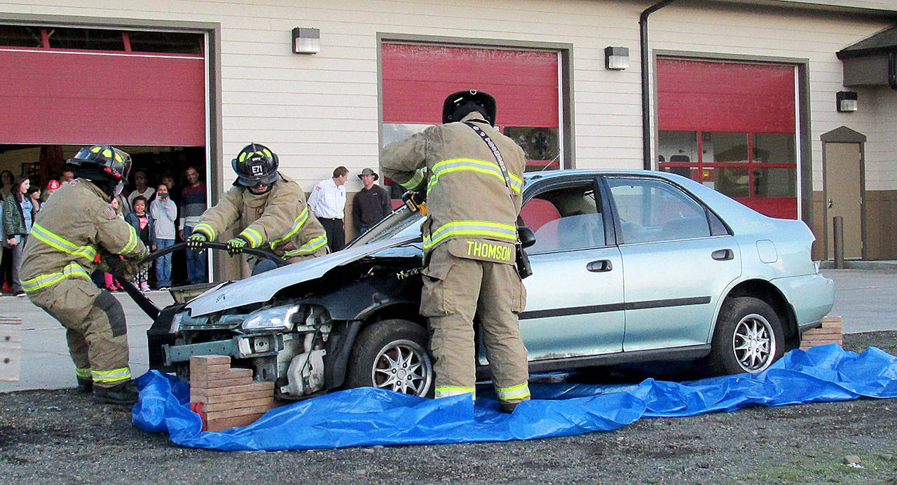 SCOTT D. JOHNSTON PHOTOS: Ocean Shores Firefighters demonstrate how they use the Jaws of Life in car accidents during the Fire Department Open House on Oct. 12.