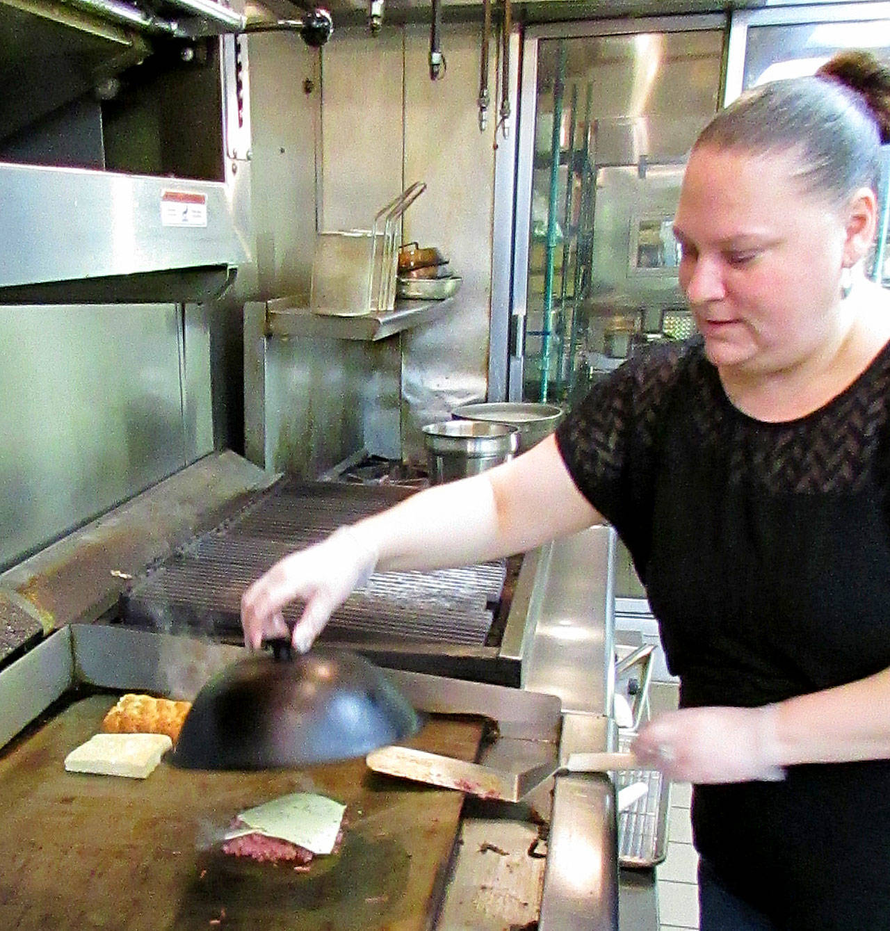 Scott D. Johnston photo: Working her culinary craft on a Reuben sandwich is Danica Thomas, chef, general manager and now owner of the Ocean Grill Ocean Shores.