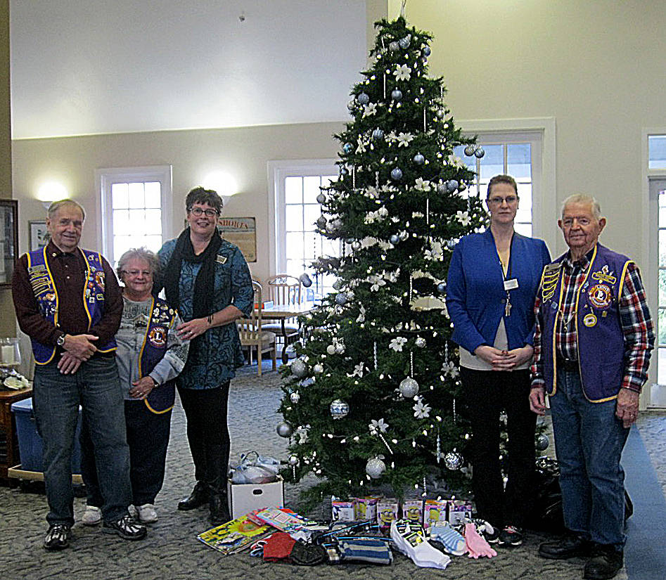 Lions Club photo: Ocean Shores Lions Club members donated presents and Christmas cheer to the folks at Brookdale Senior Living on Catala Avenue. Photo courtesy Tim Milligan, Lions Club secretary.