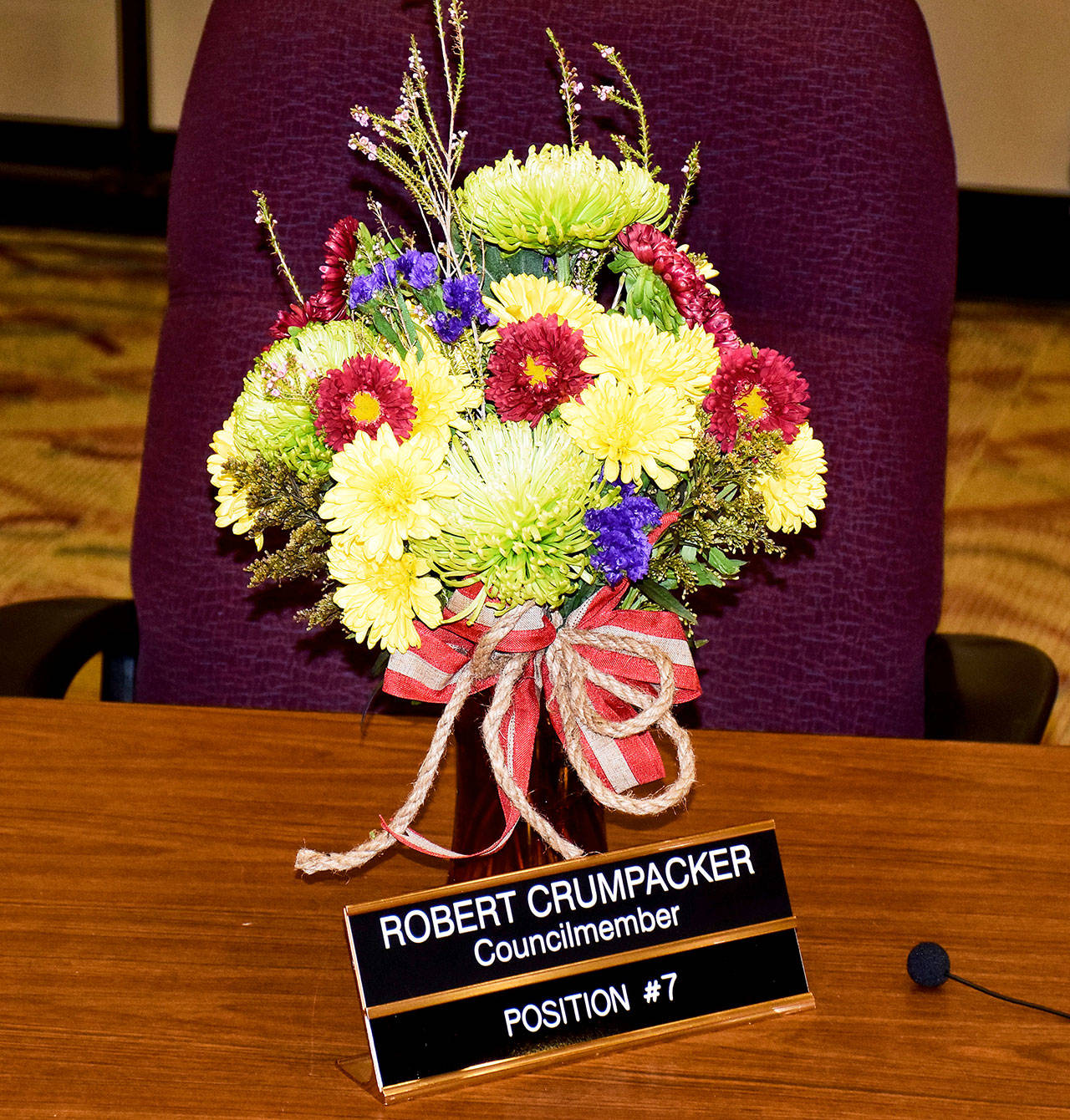 Flowers were placed at Robert Crumpacker’s seat for the March 26 City Council meeting. Because of his death, the council will choose from list of applications that are due by April 5. Scott D. Johnston photo