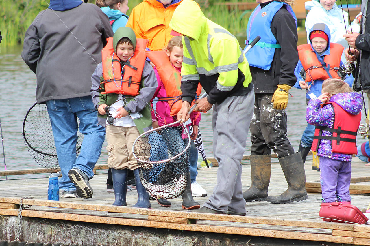 North Coast News file: A large trout is netted on the dock at North Bay Park during last year’s Youth Fishing Derby, which is this Saturday in Ocean Shores.