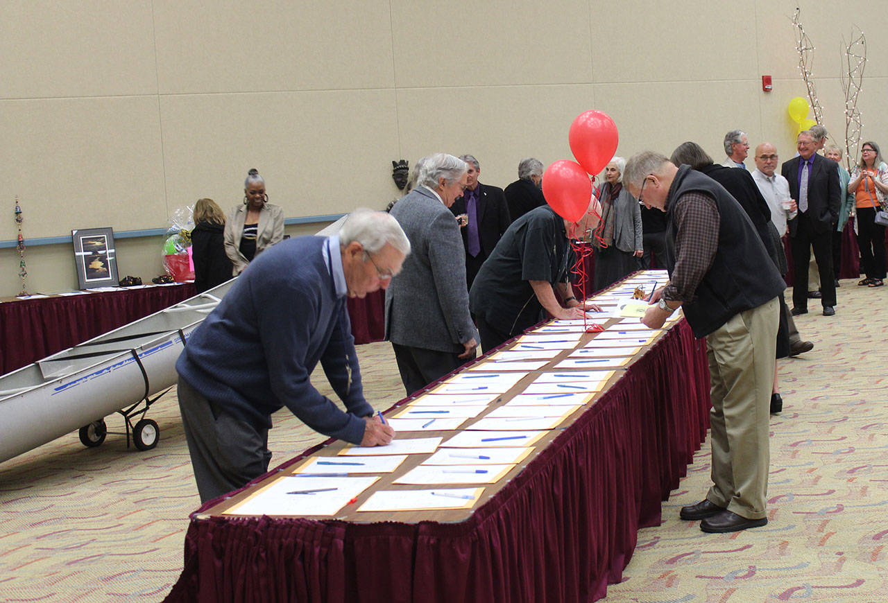 Bids are taken on items up for auction during the annual Kiwanis Scholarship Auction and Awards Banquet at the Convention Center.