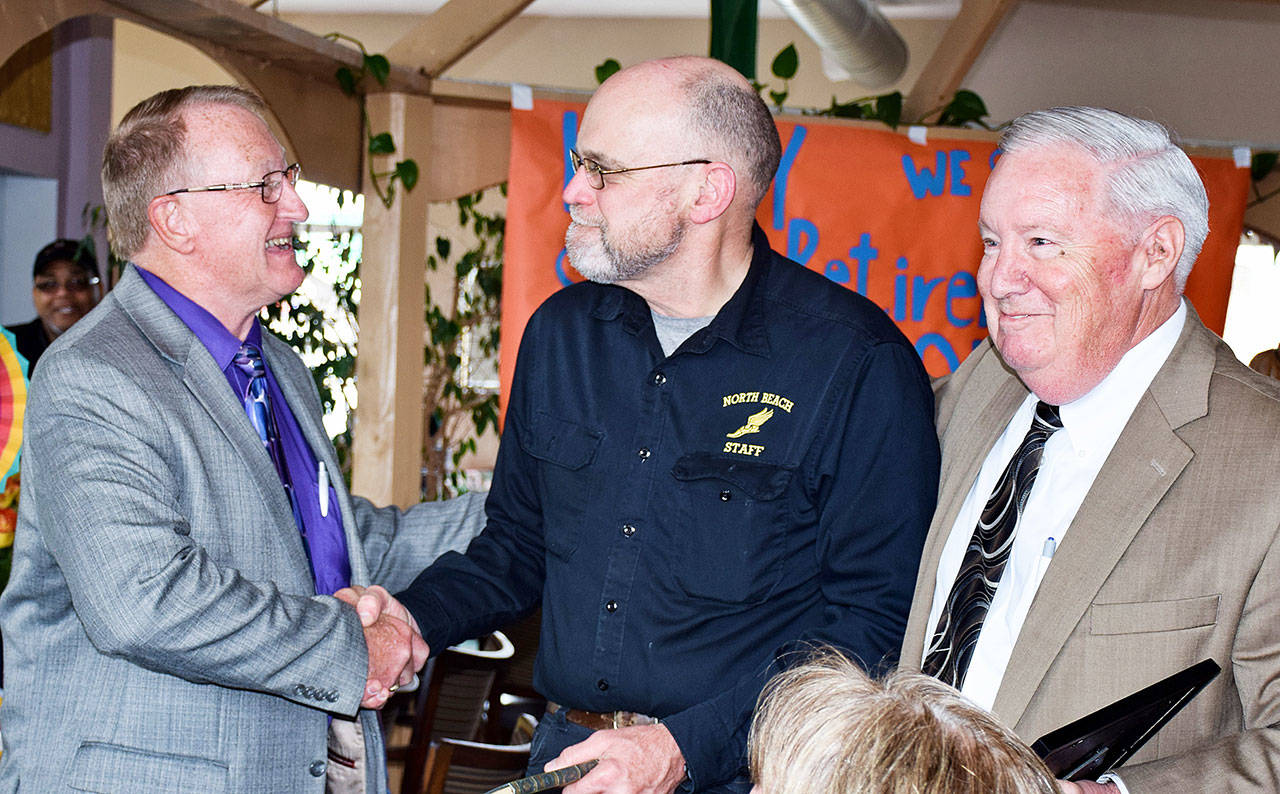 Scott D. Johnston photo: Paul Bouma, center, is congratulated by interim co-Superintendents Dave Wayman, left, and Stan Pinnick at his retirement party after 30 years teaching at North Beach.