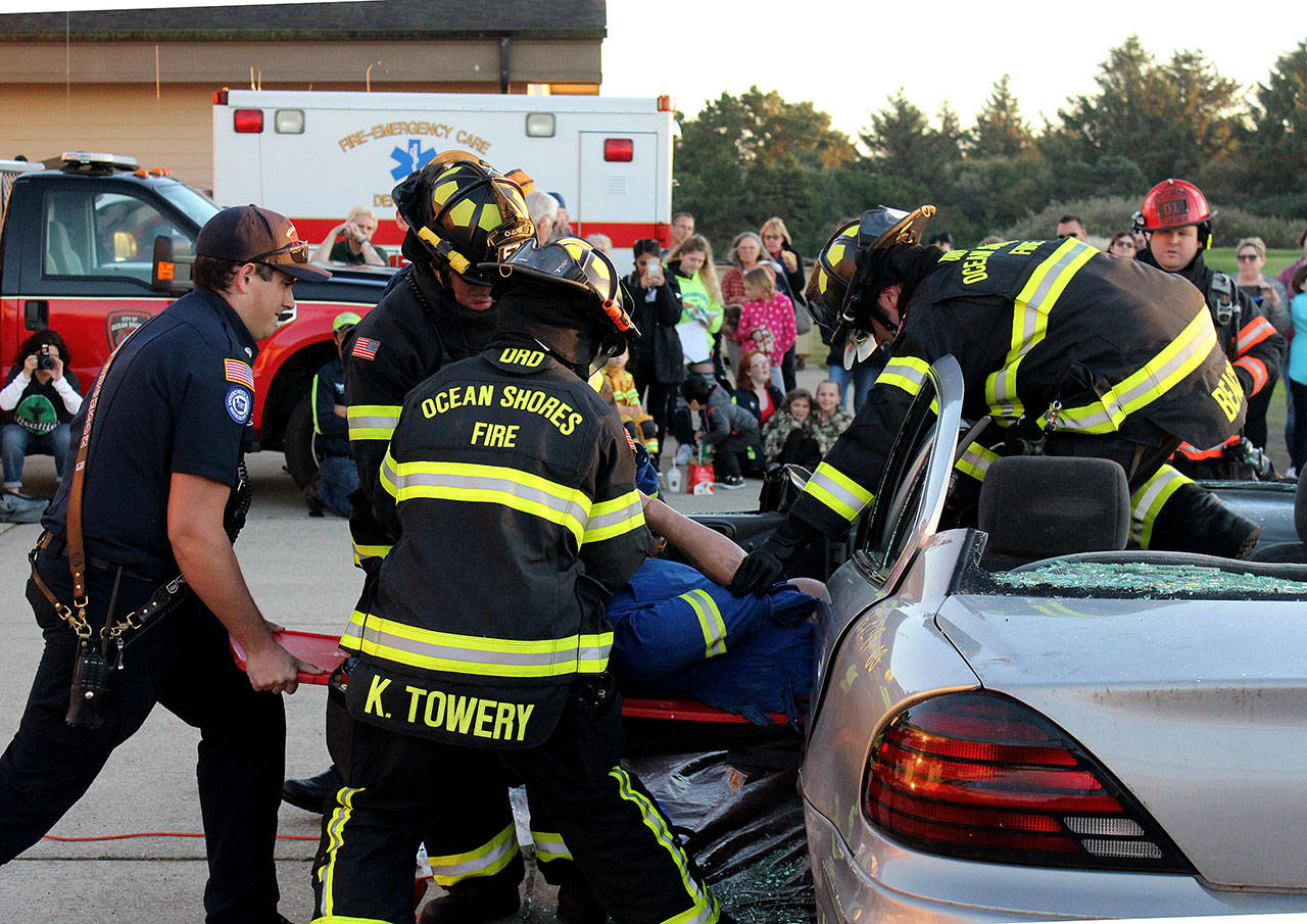 Angelo Bruscas/North Coast News: Ocean Shores Firefighters demonstrate how they rescue someone trapped in a car during the Open House last week.