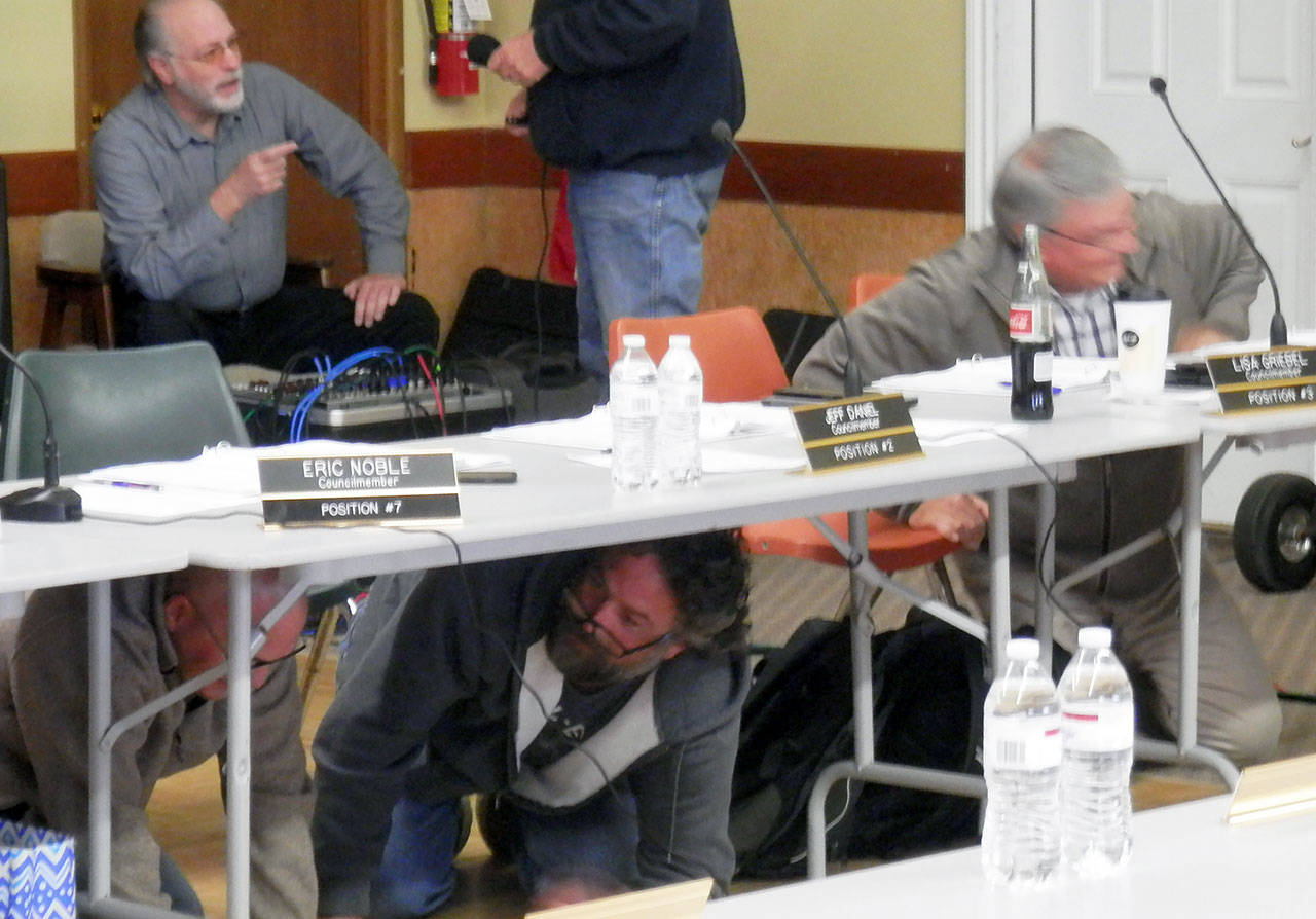 North Coast News: Members of the Ocean Shores City Council take cover under their meeting table during the GreatShakeout exercise that occurred during their first study session on the 2019-2020 budget.