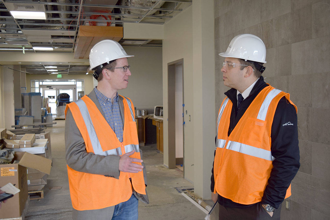 Courtesy Nichole Pas, Summit Pacific Medical Center                                Rep. Derek Kilmer, left, and Summit Pacific Medical Center CEO Josh Martin tour the hospital’s Wellness Center, which is under construction, on Monday in Elma. The facility is slated to open next month.