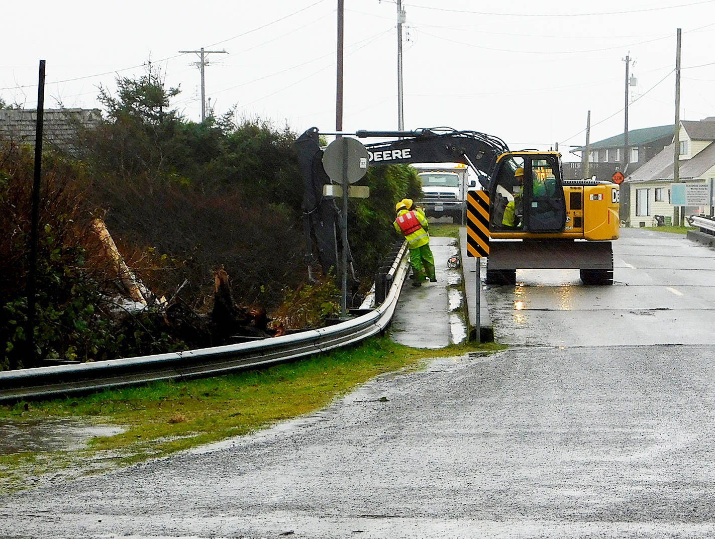 (Photo courtesy of Kelly Calhoun, Museum of the North Beach) A Grays Harbor County crew works to remove debris that had become lodged against the 2nd Street bridge over the Moclips River, which swelled with heavy rains.
