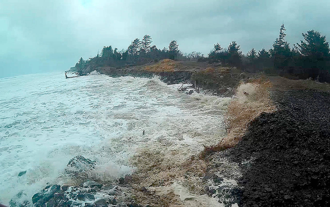 PHOTO COURTESY OF CONNIE ALLEN                                The North Cove shoreline at the end of Seamobile Drive was pounded by surf during the Dec. 20 storm, but the cobble piled up by locals to protect the rapidly eroding shoreline appeared to do its job, keeping the loss of land to a minimum.
