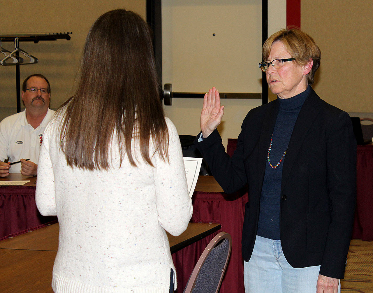 Angelo Bruscas photo: Kathryn Sprigg takes the oath of office from Angela Folkers after being selected from among seven applicants for the open Ocean Shores City Council Position 2 on Monday.                                Angelo Bruscas photo: Kathryn Sprigg takes the oath of office from Angela Folkers after being selected from among seven applicants for the open Ocean Shores City Council Position 2 on Monday.