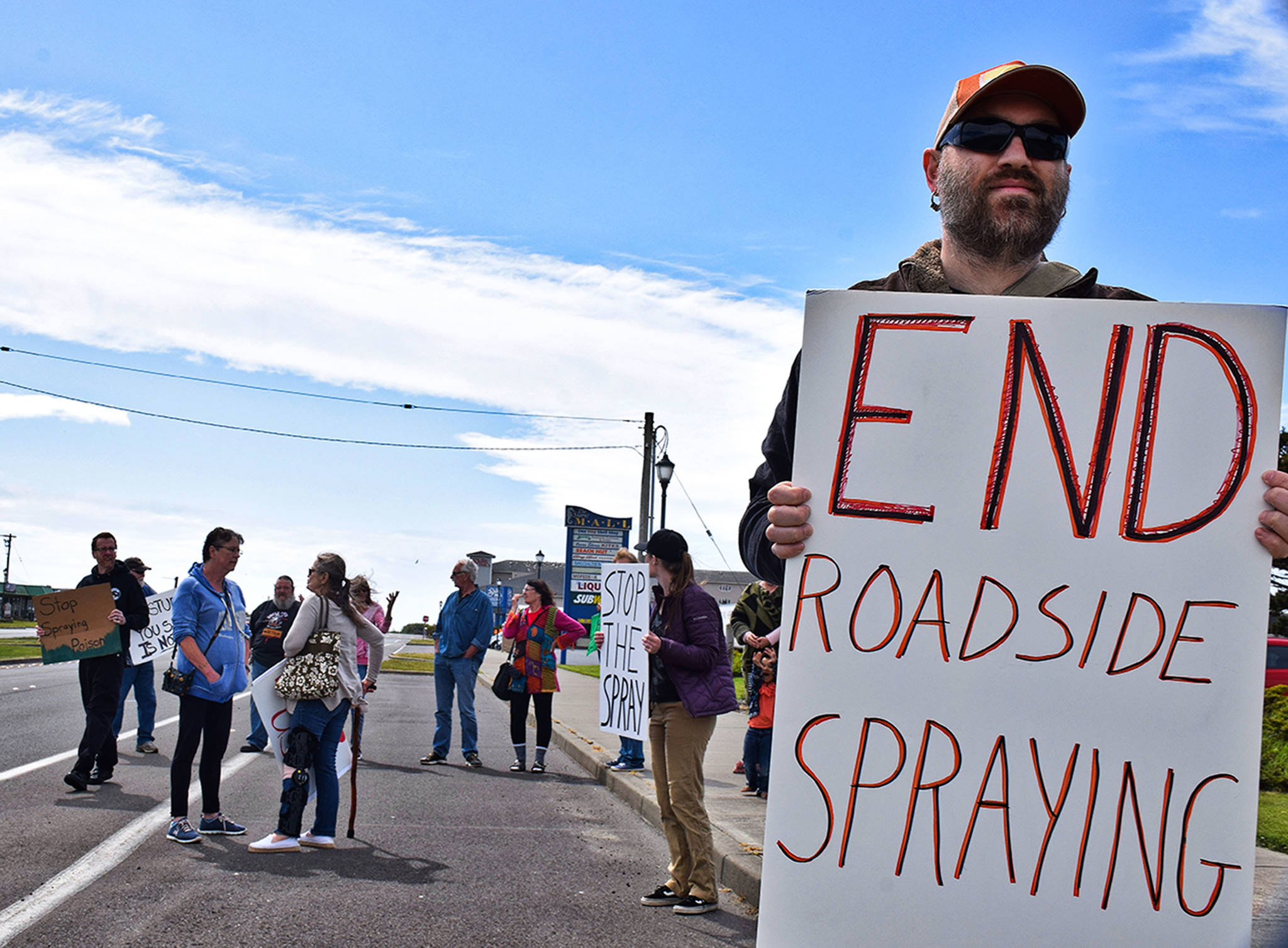photos by Scott Johnson | Grays Harbor News Group                                Ocean Shores resident Matt Cyphert was among about 15 who gathered on Chance a la Mer Blvd. in front of the Convention Center last week to protest the roadside weed spraying in the city.