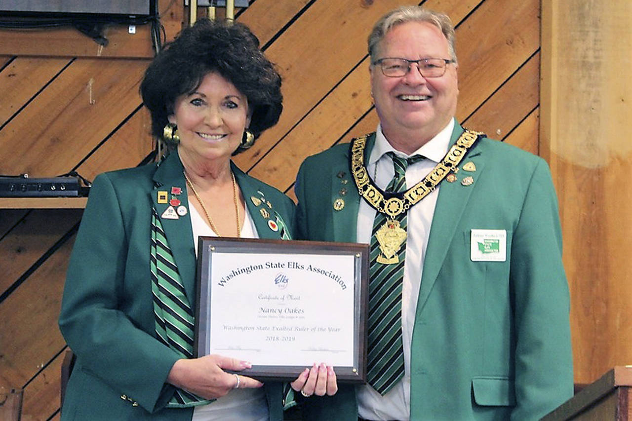 Courtesy photo                                Nancy M. Oakes, of Ocean Shores-North Beach Elks Lodge, was named Exalted Ruler of the Year for both the district and the state. Current Exalted Ruler Tony Woodbeck presented her with the award June 19.