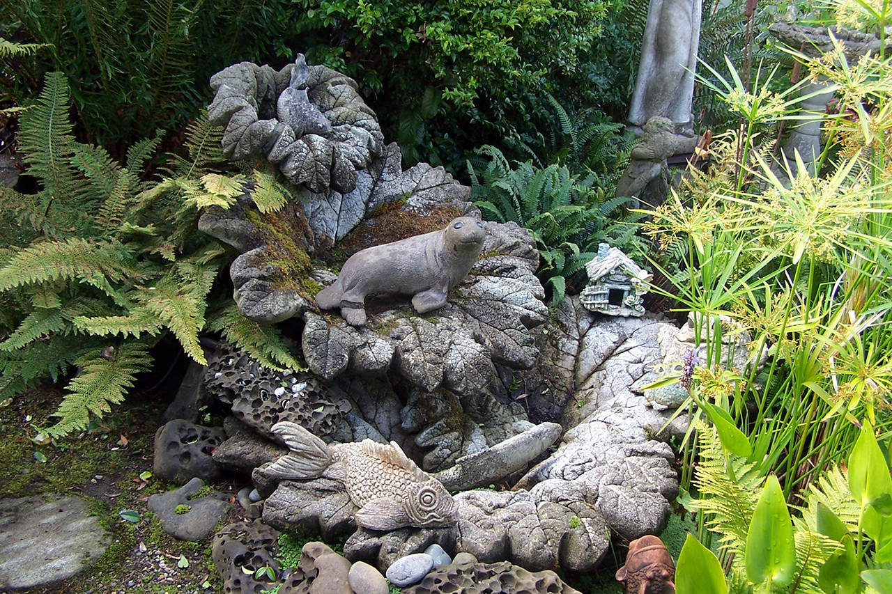 Courtesy photos                                The 20-year-old “Beauty and the Bay” garden mixes greenery galore with engaging garden art.