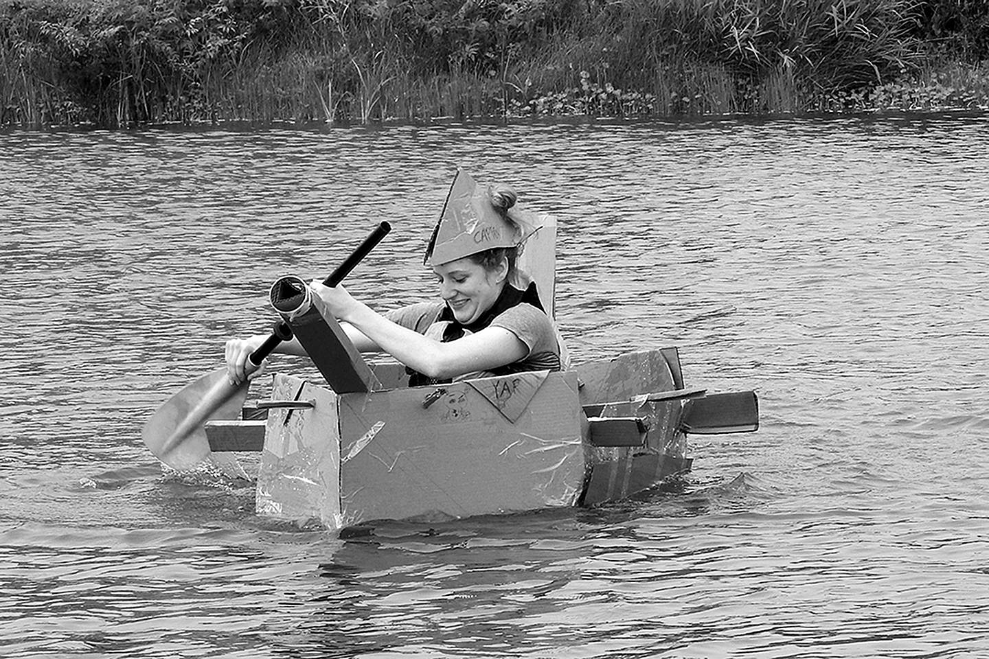 Kat Bryant | Grays Harbor News Group                                Kennedy Birley of Lacey frantically paddles her team’s cardboard creation, the Yar, back to shore during Saturday’s event at Oyhut Bay.