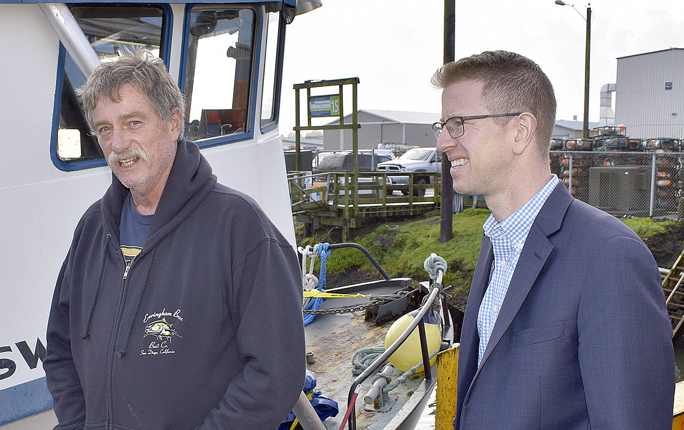 DAN HAMMOCK | GRAYS HARBOR NEWS GROUP                                Al Carter of Ocean Gold Seafood, left, talks with Congressman Derek Kilmer in Westport Friday. Kilmer met with a group of commercial and charter fishing representatives to talk about the challenges facing the industry.