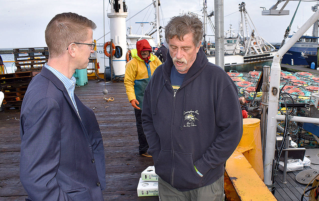 DAN HAMMOCK | GRAYS HARBOR NEWS GROUP                                Congressman Derek Kilmer, left, talks to Ocean Gold Seafood’s Al Carter in Westport Friday morning as commercial crab boats prepare for today’s season opener. Kilmer was in town to talk commercial and charter fishing with a group of charter, commercial, port and shellfish industry representatives.
