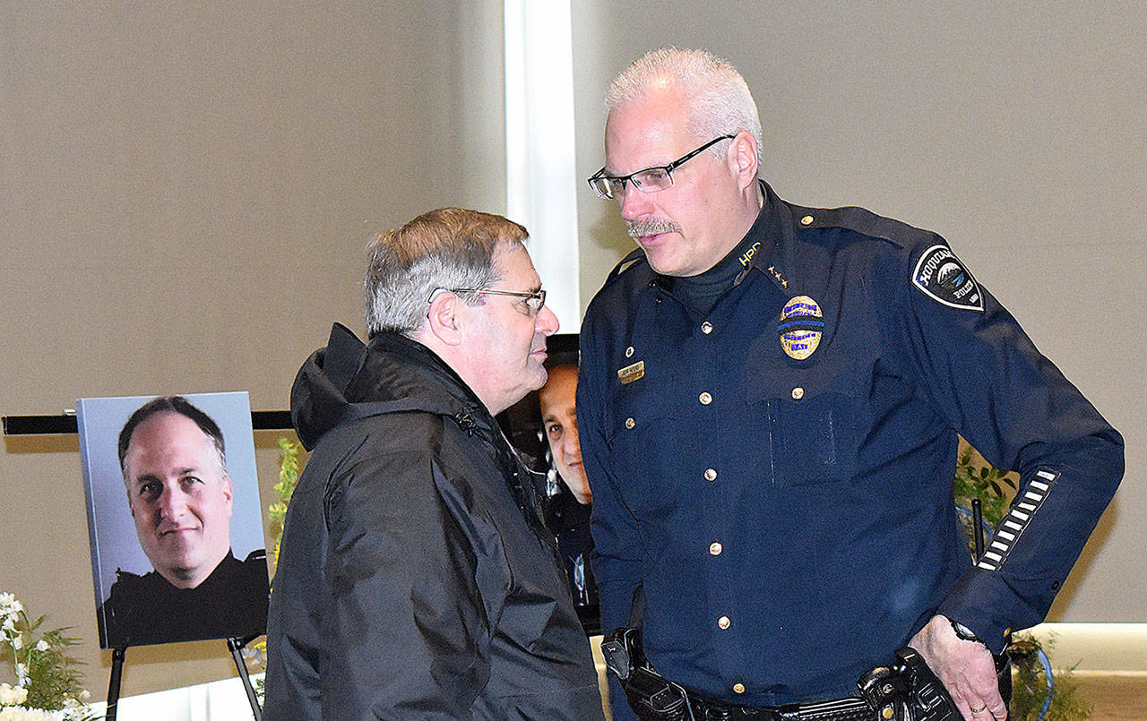 DAN HAMMOCK | GRAYS HARBOR NEWS GROUP                                Hoquiam Police Chief Jeff Myers and retired Aberdeen Police officer Tom Siress talk after the memorial service for Hoquiam Police Officer Phil High Saturday in Ocean Shores.