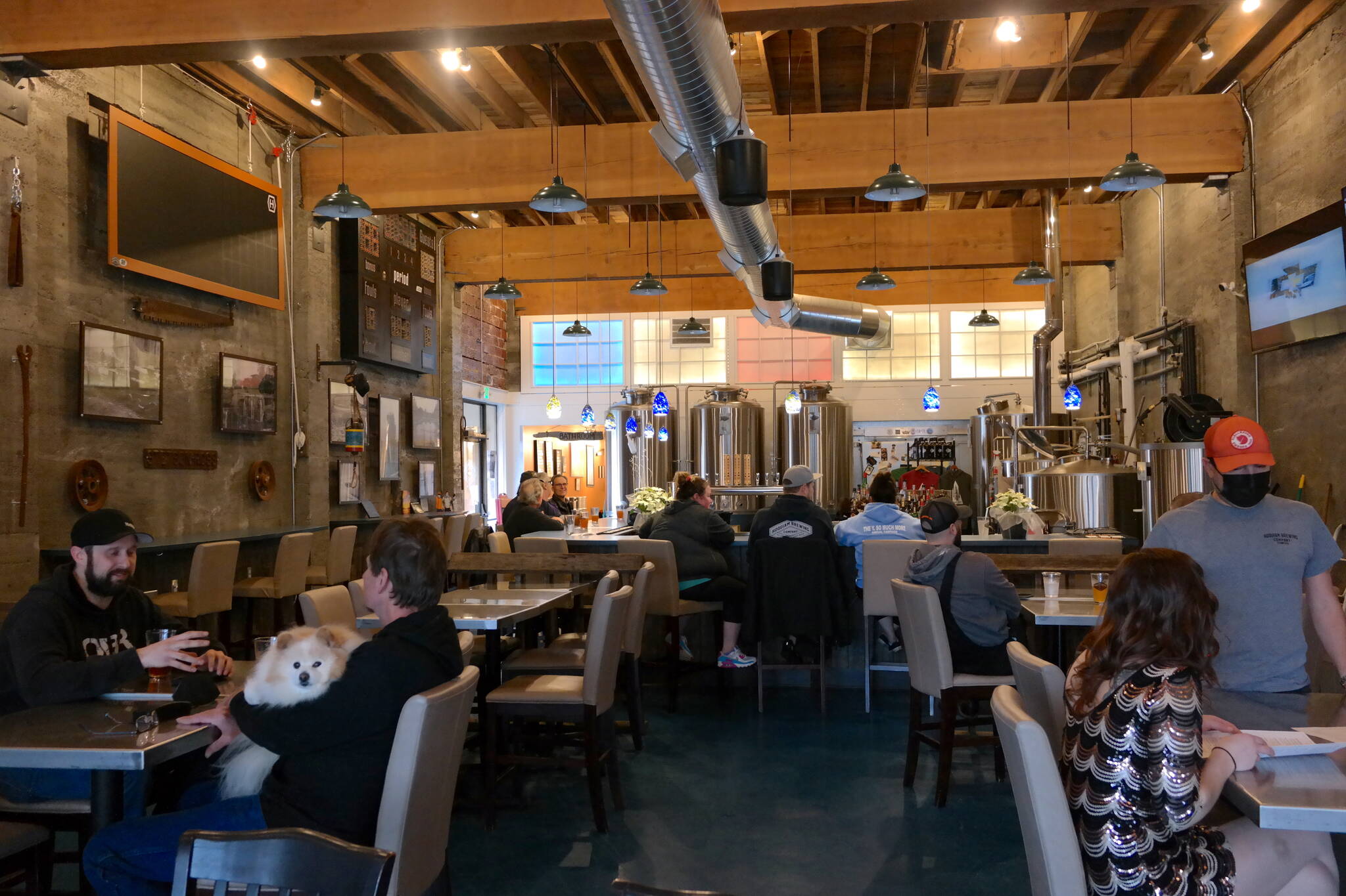 Patrons enjoy a Friday afternoon at Hoquiam Brewing Co. on Feb. 18, 2022. According to co-owner Rob Paylor, the recently expanded kitchen and dining menu has been well-received by the public and features “Northwest Brewery pub-style” cuisine. Erika Gebhardt I The Daily World