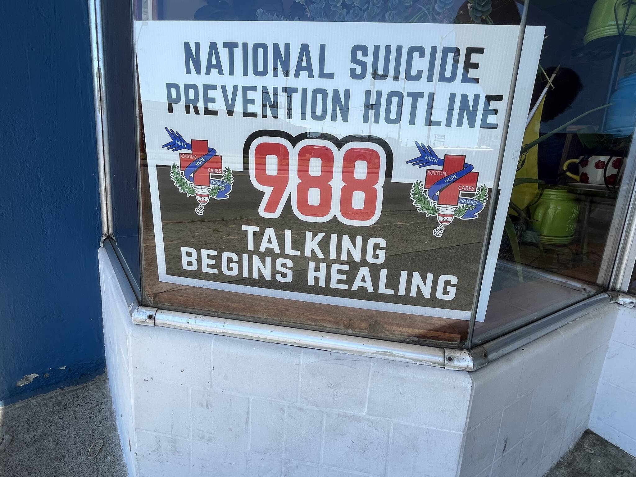 (Matthew N. Wells | The Daily World)
                                The National Suicide Prevention Hotline, which is transitioning from its 1-800-273-8255 phone number to 988, connects those experiencing mental health crises, such as suicide, with mental health professionals. The number, and the slogan, are sitting behind a window at Harbor Calvary Chapel.